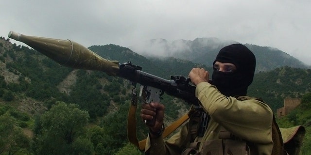 In this photo taken on Aug. 5, 2012, a Pakistani Taliban militant holds a rocket-propelled grenade at the Taliban stronghold of Shawal, South Waziristan, Pakistan. Taliban leaders will hold a meeting to decide whether a Pakistani cricket star-turned-politician Imran Khan will be allowed to hold a planned march to their tribal stronghold to protest U.S. drone strikes, the militant group's spokesman said Thursday. (AP Photo/ Ishtiaq Mahsud)