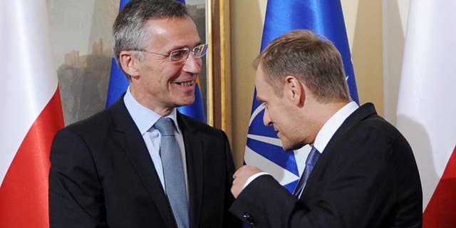 Polish Prime Minister Donald Tusk, right, gestures, as he meets NATO Secretary General designate Jens Stoltenberg, prior to talks in Warsaw, Poland, Wednesday, June 25, 2014. (AP Photo/Alik Keplicz)