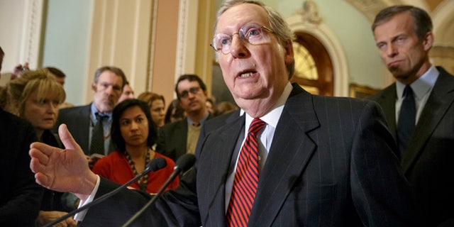 Senate Majority Leader Mitch McConnell of Ky., accompanied by Sen. John Thune, R-S.D., right, meets with reporters on Capitol Hill in Washington, Tuesday, Feb. 24, 2015, to talk about his move to disentangle one of two contested immigration measures from the Homeland Security budget and debate the issues separately, as the Senate faces an impasse over provisions attached to the spending bill aimed at blocking President Barack Obama's executive actions on immigration. (AP Photo/J. Scott Applewhite)