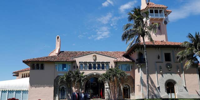 President Donald Trump, left, and Chinese President Xi Jinping pause in their walk after their meetings at Mar-a-Lago, Friday, April 7, 2017, in Palm Beach, Fla. (AP Photo/Alex Brandon)