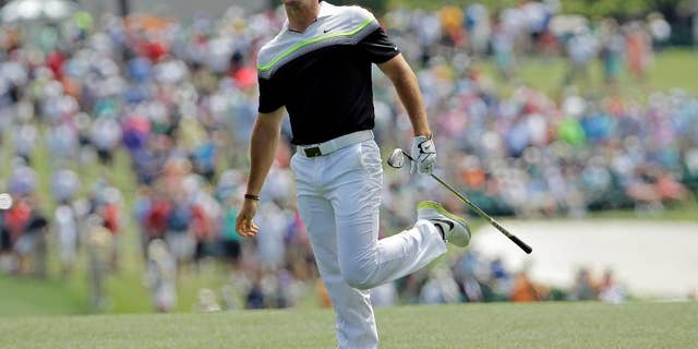 Rory McIlroy, of Northern Ireland, watches his shot after hitting on the first fairway during the third round of the Masters golf tournament Saturday, April 11, 2015, in Augusta, Ga. (AP Photo/David J. Phillip)