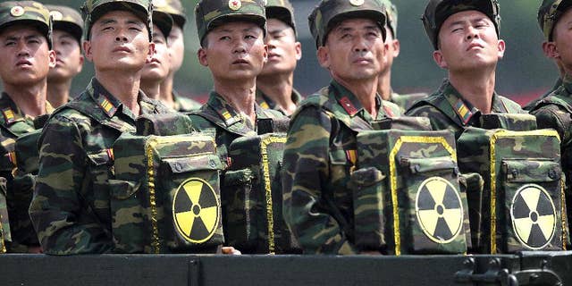 FILE - In this July 27, 2013, file photo, North Korean soldiers turn and look towards their leader Kim Jong Un from a military parade vehicle as they carry packs marked with the nuclear symbol during a ceremony marking the 60th anniversary of the Korean War armistice in Pyongyang, North Korea. On Friday, Dec. 2, 2016, North Korea says a sweeping new round of U.N. sanctions aimed at choking its nuclear program by cutting off as much of a quarter of its foreign trade revenue is an "abuse of power" and will be met with tough countermeasures. (AP Photo/Wong Maye-E, File)