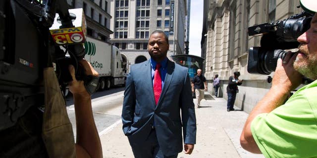 Baltimore police Officer William Porter, one of six Baltimore city police officers charged in connection to the death of Freddie Gray, leaves the courthouse, after testifying in the trial of Officer Caesar Goodson, Monday, June 13, 2016, in Baltimore Md. Porter's trial in the Gray case ended in mistrial. He will be tried again in September. (AP Photo/Jose Luis Magana)