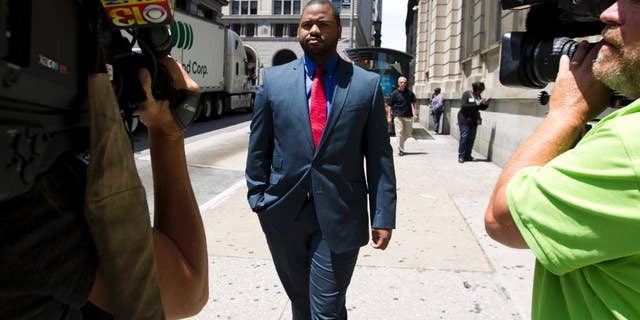 Baltimore police Officer William Porter, one of six Baltimore city police officers charged in connection to the death of Freddie Gray, leaves the courthouse, after testifying in the trial of Officer Caesar Goodson, Monday, June 13, 2016, in Baltimore Md. Porter's trial in the Gray case ended in mistrial. He will be tried again in September. (AP Photo/Jose Luis Magana)