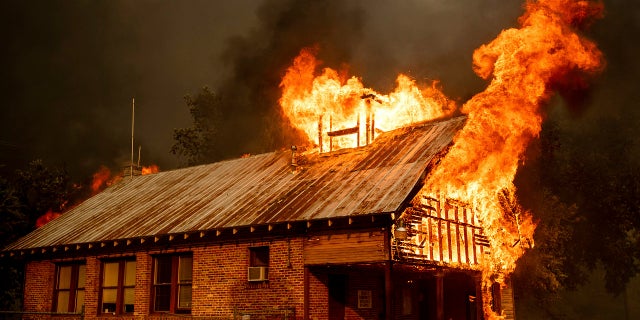 A historic schoolhouse burns as the Carr Fire tears through Shasta, Calif., July 26, 2018.