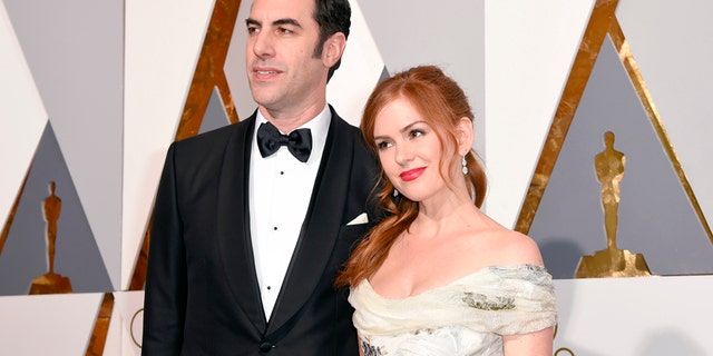 Sacha Baron Cohen, left, and Isla Fisher arrive at the Oscars on Sunday, Feb. 28, 2016, at the Dolby Theatre in Los Angeles. (Photo by Dan Steinberg/Invision/AP)