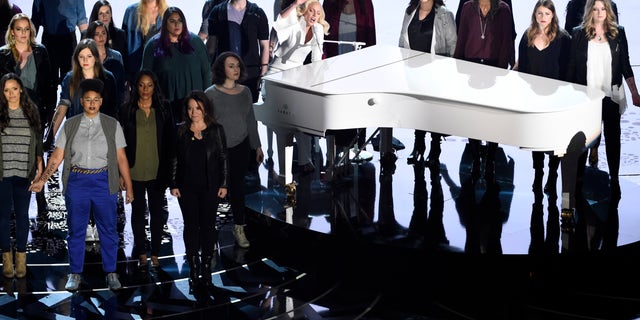 Lady Gaga, center, performs "Til It Happens To You" that is nominated for best original song from "The Hunting Ground" on stage with survivors of abuse at the Oscars on Sunday, Feb. 28, 2016, at the Dolby Theatre in Los Angeles. (Photo by Chris Pizzello/Invision/AP)