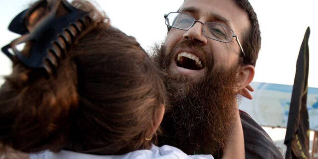 FILE - In this Sunday, July 12, 2015 file photo, Palestinian Khader Adnan hugs his daughter after his release from an Israeli prison in the West Bank village of Arrabeh near Jenin. Israeli police said they have detained Adnan again, just a day after he was released from Israeli custody. Police said Adnan was detained Monday in Jerusalem's Old City because he didn't have an Israeli permit to be in the area. He was detained as throngs of Muslim worshippers were visiting Jerusalem for a Muslim holy night. (AP Photo/Majdi Mohammed, File)