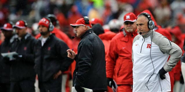 Rutgers head coach Kyle Flood, right, watches from the sidelines during the second half of an NCAA college football game against Wisconsin, Saturday, Nov. 1, 2014, in Piscataway, N.J. Wisconsin won 37-0. (AP Photo/Mel Evans)