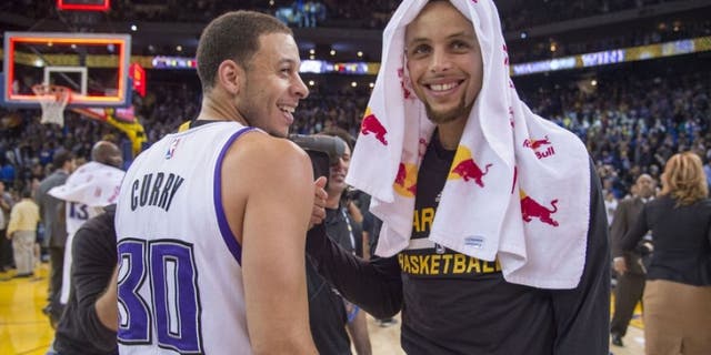 November 28, 2015; Oakland, CA, USA; Sacramento Kings guard Seth Curry (30, left) smiles while talking with Golden State Warriors guard Stephen Curry (30, right) after the game at Oracle Arena. The Warriors defeated the Kings 120-101. Mandatory Credit: Kyle Terada-USA TODAY Sports