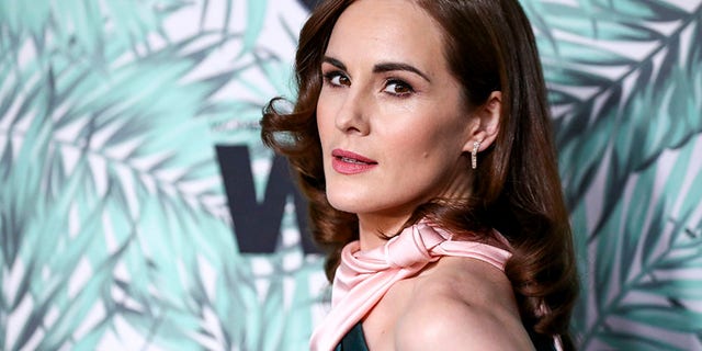FILE - In this Feb. 24, 2017, file photo, Michelle Dockery arrives at the 10th Annual Women in Film Pre-Oscar Cocktail Party at Nightingale Plaza in Los Angeles. Filming has begun for the 'Downton Abbey' movie. Dockery, who plays Lady Mary in the global hit, posted a photo on Instagram with the caption, 'And...we're off.'