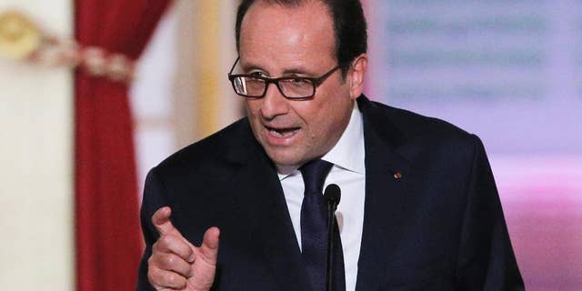 French President Francois Hollande answers reporters after deliver his press conference at the Elysee Palace, Thursday, Sept.18, 2014. Hollande said he agreed to Iraq's request for air support at a meeting of his top defense and security advisers earlier Thursday. (AP Photo/Christophe Ena)