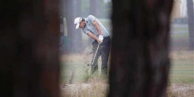 Brooks Koepka hits from the natural area on the 12th hole during the second round of the U.S. Open golf tournament in Pinehurst, N.C., Friday, June 13, 2014. (AP Photo/David Goldman)