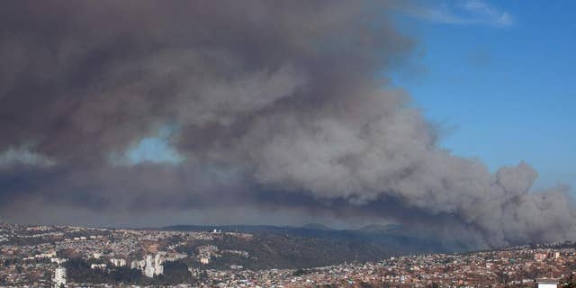 Plumes of smoke from a wild fire rise over Valparaiso, Chile, Friday, March 13, 2015. A serious forest fire spread quickly on Chile's coast Friday and threatened to reach the nearby port cities of Valparaiso and Vina del Mar. Deputy Interior Secretary Mahmud Aleuy said that thousands have been evacuated as flames advanced nearby. (AP Photo)
