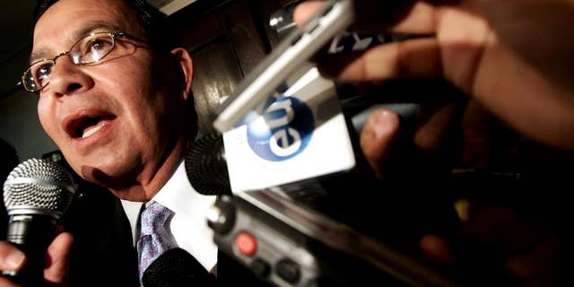 FILE - In this Sep. 20, 2006 file photo, Honduras' former President Rafael Leonardo Callejas speaks to the press in Tegucigalpa, Honduras. Honduras’ foreign minister said on Monday, Dec. 14, 2015 that the ex-president, who also served as president of Honduras' soccer federation, has boarded a private plane with the intention of turning himself in to U.S. authorities investigating corruption and kickbacks in FIFA, soccer's scandal-plagued governing body. The United States had previously requested Callejas’ extradition. (AP Photo/Edgard Garrido, File)