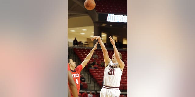 Arizona State's Jonathan Gilling shoots a 3-point basket over Texas Tech's Ty Nurse during an NCAA college basketball game in Lubbock, Texas, Saturday, Dec. 22, 2012. (AP Photo/Lubbock Avalanche-Journal, Zach Long) LOCAL TV OUT