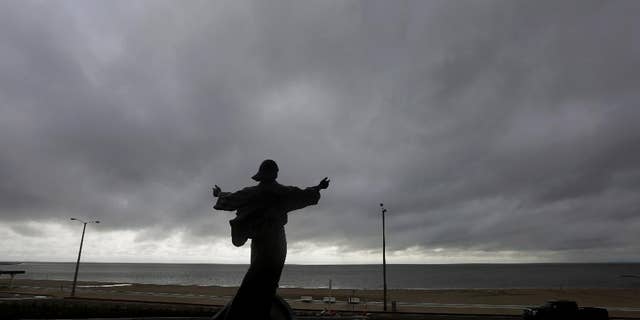 A statue of Jesus Calming the Sea titled "It is me" faces the bay and gulf in Corpus Christi, Tuesday, June 16, 2015, as Tropical Storm Bill begins to make landfall.