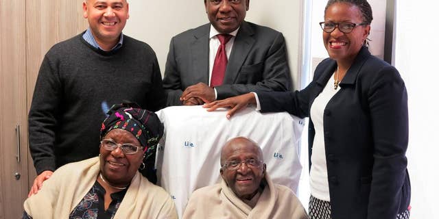 This image provided by Oryx Media shows Nobel laureate Desmond Tutu, front right, with his wife Leah Tutu, front left, with South African deputy president Cyril Ramaphosa, rear center. Rear left is ANC regional secretary, Faiz Jacobs and Mpho Tutu-Van Furth rear right. Ramaphosa celebrated a Eucharist service with the Tutu family in his Cape Town, South Africa, hospital bed. (Benny Gool/Oryx Media via AP)