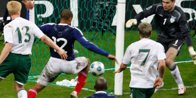 File - France's Thierry Henry, left, passes the ball as Ireland's goalkeeper Shay Given, right, tries to stop it, just before William Gallas (unseen) scored the goal for France during their World Cup qualifying playoff second leg soccer match at the Stade de France stadium in Saint Denis outside Paris, Wednesday, Nov. 18, 2009. FIFA has admitted to giving Ireland $5 million in compensation for missing out on a place at the 2010 World Cup after Thierry Henry's handball that set up the French winner. The payment _ initially a loan _ was not disclosed in the wake of the 2009 playoff game, which France won 2-1 on aggregate to reach the finals in South Africa. The cash from FIFA was first disclosed in public on Thursday June 4 2015 by Football Association of Ireland chief executive John Delaney, who didn't say it was a loan. (AP Photo / Michel Euler, file)