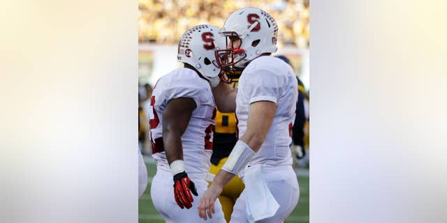 Stanford's Remound Wright, left, celebrates with quarterback Kevin Hogan after Wright scored a touchdown against California during the second half of an NCAA college football game Saturday, Nov. 22, 2014, in Berkeley, Calif. (AP Photo/Ben Margot)