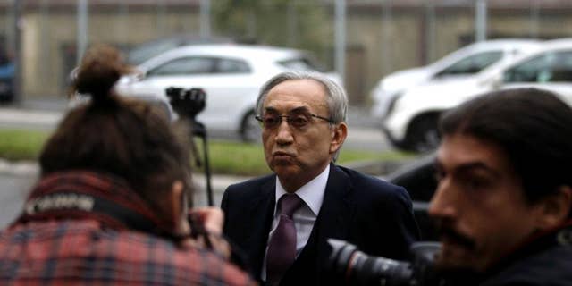 FILE In this Thursday, Nov. 14, 2013 file photo, Serbian tycoon Miroslav Miskovic, center, walks past the media as he arrives for the start of his court case on charges alleging embezzlement and tax evasion, in Belgrade, Serbia. A Serbian court sentenced on Monday, June 20, 2016 one of the richest businessmen in the Balkans to five years in prison for tax evasion in a trial that the government sees as a major effort to curb corruption as it seeks European Union membership. Miskovic was once among the most influential people in Serbia with close political ties. He was found guilty by the anti-graft court for helping his son Marko evade paying some 3 million euros ($3.4 million) in taxes linked to his road construction business. (AP Photo / Marko Drobnjakovic, FIle)