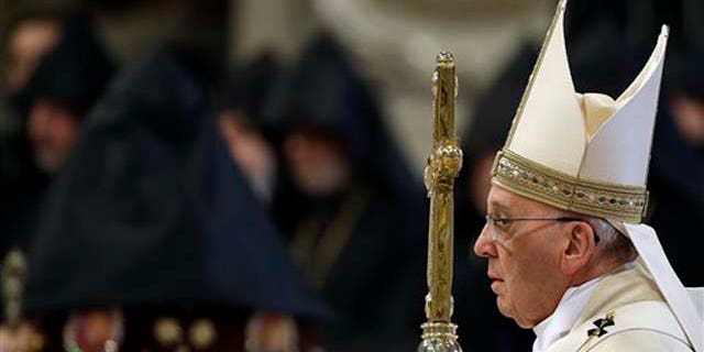 Pope Francis arrives to celebrates an Armenian-Rite Mass on the occasion of the commemoration of the 100th anniversary of the Armenian Genocide, in St. Peter's Basilica, at the Vatican Sunday, April 12, 2015. Historians estimate that up to 1.5 million Armenians were killed by Ottoman Turks around the time of World War I, an event widely viewed by genocide scholars as the first genocide of the 20th century. Turkey however denies that the deaths constituted genocide, saying the toll has been inflated, and that those killed were victims of civil war and unrest. (AP Photo/Gregorio Borgia)