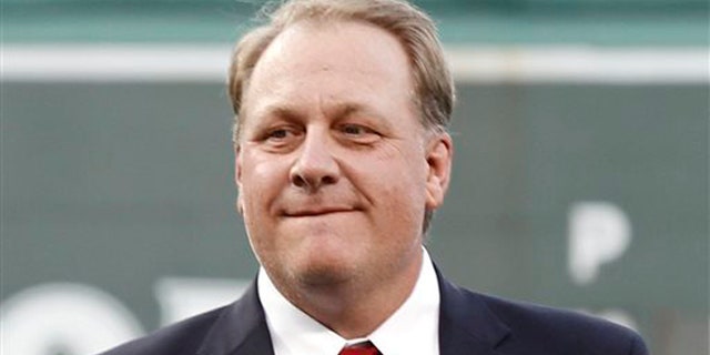 FILE - In this Aug. 3, 2012, file photo, former Boston Red Sox pitcher Curt Schilling looks on after being introduced as a new member of the Boston Red Sox Hall of Fame before a baseball game between the Red Sox and the Minnesota Twins at Fenway Park in Boston. Schilling is defending himself after making comments on social media about transgender people, saying he was expressing his opinion. (AP Photo/Winslow Townson, File)