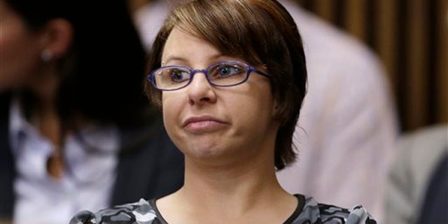 FILE - In this Thursday, Aug. 1, 2013 file photo, Michelle Knight sits in the courtroom during the sentencing phase for Ariel Castro in Cleveland. Knight, one of three women who escaped from a ramshackle Cleveland home after more than a decade in captivity, is scheduled to appear on the "Dr. Phil" TV talk show Tuesday, Nov. 5, 2013 and Wednesday in a taped interview. (AP Photo/Tony Dejak)