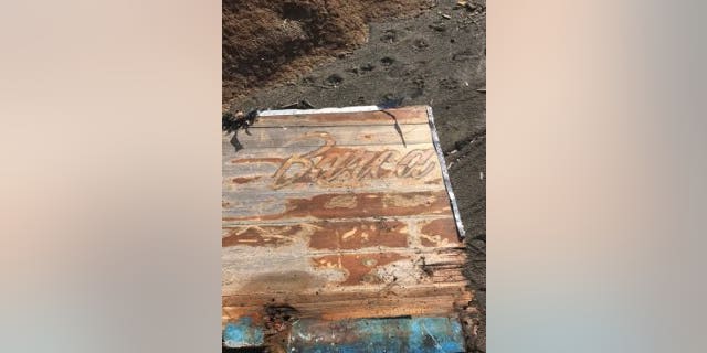 Photos posted by the Coast Guard shows pieces of a wooden boat that has the name "Rio" and "Barca" on it.