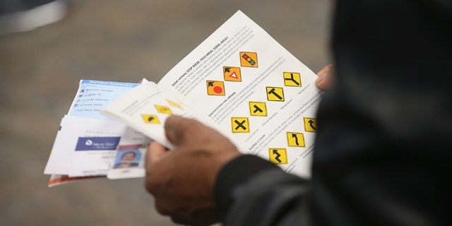 CHICAGO, IL - DECEMBER 10: An Illinois resident uses a Spanish-language study guide to prepare for his driver's license exam at a driver services facility on December 10, 2013 in Chicago, Illinois. Illinois recently began a Temporary Visitors Driver's License (TVDL) program which allows undocumented immigrants to obtain a driver's license. The applicants must have an Illinois address, prove 12 months of residency in the state, and have a valid passport or consular card to be eligible. (Photo by Scott Olson/Getty Images)