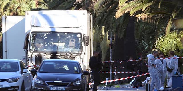 The truck which slammed into revelers late Thursday, July 14, is seen near the site of an attack in the French resort city of Nice, southern France, Friday, July 15, 2016. France has been stunned again as a large white truck mowed through a crowd of revelers gathered for a Bastille Day fireworks display in the Riviera city of Nice. (AP Photo/Luca Bruno)