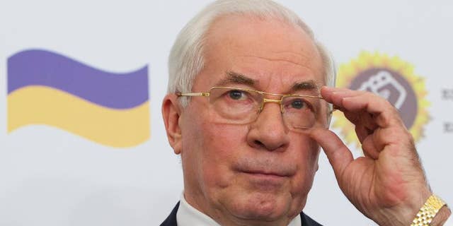Mykola Azarov gestures as he speaks at a news conference in a Moscow hotel, Monday, Aug. 3, 2015. Ukraine’s former prime minister who has fled the country following the ouster of its Moscow-friendly president has announced the creation of a ‘Ukraine salvation committee’ and pushed for early presidential and parliamentary elections. (AP Photo/Ivan Sekretarev)