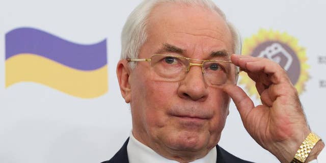 Mykola Azarov gestures as he speaks at a news conference in a Moscow hotel, Monday, Aug. 3, 2015. Ukraine’s former prime minister who has fled the country following the ouster of its Moscow-friendly president has announced the creation of a ‘Ukraine salvation committee’ and pushed for early presidential and parliamentary elections. (AP Photo/Ivan Sekretarev)