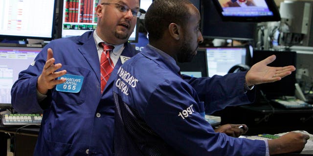 In this Aug. 11, 2010 photo, specialist John Urbanowicz, left, talks with a colleague on the floor of the New York Stock Exchange. Stocks are opening Wednesday, May 22, 2013, slightly higher as investors watch for the latest moves from the Federal Reserve. (AP Photo/Richard Drew)