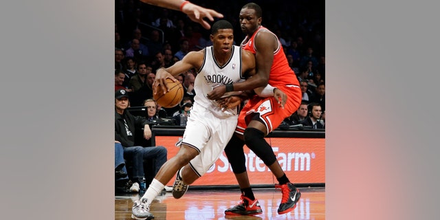 Brooklyn Nets guard Joe Johnson, left, tries to drive past Chicago Bulls forward Luol Deng in the first half of Game 2 of their first-round NBA basketball playoff series, Monday, April 22, 2013, in New York. (AP Photo/Kathy Willens)