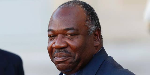 FILE - In this Tuesday, Nov. 10, 2015 file photo, Gabon's President Ali Bongo Ondimba leaves the Elysee Palace after a meeting with French President Francois Hollande as part of preparation of the upcoming COP21 Climate Conference in Paris, France. Gabon's constitutional court upheld incumbent President Bongo's  victory in last month's presidential election early Saturday, Sept. 24, 2016, raising fears of continued unrest as the Bongo family extended its political dynasty of nearly half a century in the oil-rich country. (AP Photo/Francois Mori, File)