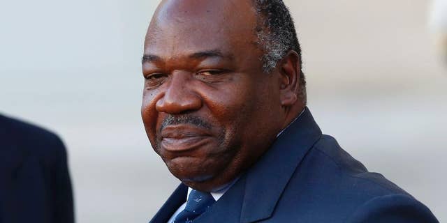 FILE - In this Tuesday, Nov. 10, 2015 file photo, Gabon's President Ali Bongo Ondimba leaves the Elysee Palace after a meeting with French President Francois Hollande as part of preparation of the upcoming COP21 Climate Conference in Paris, France. Gabon's constitutional court upheld incumbent President Bongo's victory in last month's presidential election early Saturday, Sept. 24, 2016, raising fears of continued unrest as the Bongo family extended its political dynasty of nearly half a century in the oil-rich country. (AP Photo/Francois Mori, File)