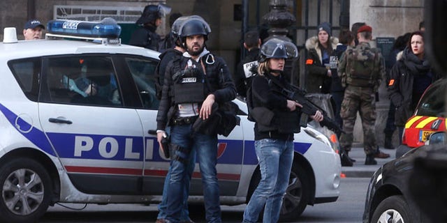 Feb.3 Police officers guard the access to the Louvre museum