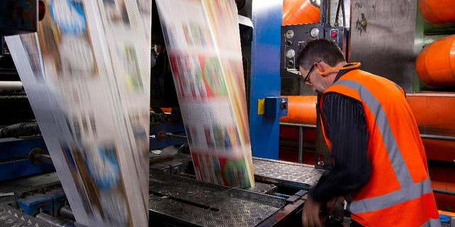 In this Sept. 9, 2012 photo, the first edition of the new compact New Zealand Herald rolls off the press in Auckland, New Zealand. Facing declining revenues and changing reader habits, New Zealand's two main newspaper groups, Fairfax Media and APN News & Media, announced Wednesday, May 11, 2016, they're discussing a merger that could end decades of competition and result in hundreds of job losses. (Sarah Ivey/New Zealand Herald via AP) NEW ZEALAND OUT, AUSTRALIA OUT