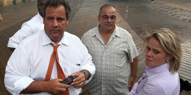 In this Sept. 12, 2013 photo provided by the Office of the Governor of New Jersey, Deputy Chief of Staff Bridget Anne Kelly, right, stands with Gov. Chris Christie, left, during a tour of the Seaside Heights, N.J. boardwalk after it was hit by a massive fire. Christie fired Kelly Thursday, Jan. 9, 2014, and apologized over and over for his staff's "stupid" behavior, insisting during a nearly two-hour news conference that he had no idea anyone around him had engineered traffic jams as part of a political vendetta against a Democratic mayor. (AP Photo/Office of Gov. Chris Christie, Tim Larsen)