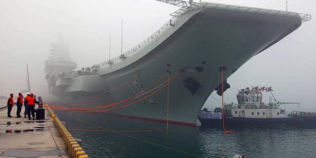 FILE - In this Feb. 27, 2013 file photo released by China's Xinhua news agency, China's first aircraft carrier, the Liaoning, is anchored in the northern port in Qingdao, east China's Shandong Province. Taiwan's defense ministry said China's sole aircraft carrier on Wednesday, Jan. 11, 2017 was transiting the Taiwan Strait amid heightened tensions between the mainland and self-governing island it claims as its own territory. (Wu Dengfeng/Xinhua via AP, File)