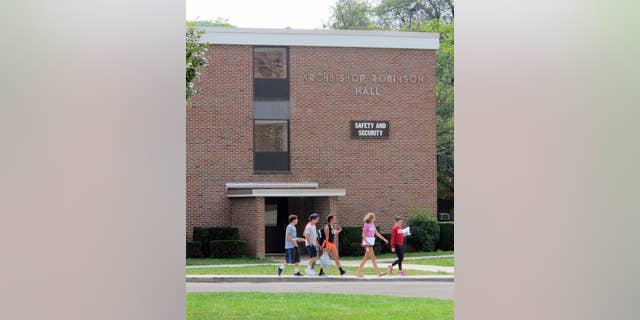 In this Aug. 29, 2015 photo, students walk past the public safety building at St. Bonaventure University in St. Bonaventure, N.Y. Students at New York state's private colleges and universities return to campus with a new, affirmative sexual consent policy to combat campus sexual violence. A bill signed by Gov. Andrew Cuomo over the summer expands on a policy in effect at public colleges which includes a "yes means yes" definition of consent requiring a clear, affirmative agreement between partners. In July, New York became the second state, after California, to write the affirmative consent standard into law for campuses. (AP Photo/Carolyn Thompson)