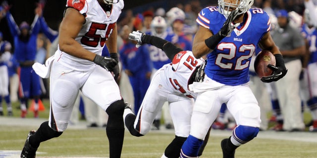 Buffalo Bills running back Fred Jackson (22) scores a touchdown past Atlanta Falcons defensive end Osi Umenyiora (50) during the second half of an NFL football game on Sunday, Dec. 1, 2013, in Toronto. (AP Photo/Gary Wiepert)