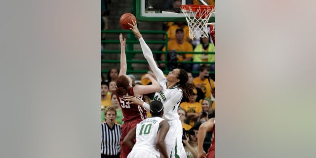 FILE - In this Jan. 26, 2013 file photo, Baylor's Brittney Griner (42) blocks the shot of Oklahoma's Joanna McFarland (53) during the second half of an NCAA college basketball game in Waco Texas. Griner was selected to the 2012-13 AP Women's All-America team, Tuesday, April 2, 2013. (AP Photo/LM Otero, FIle)