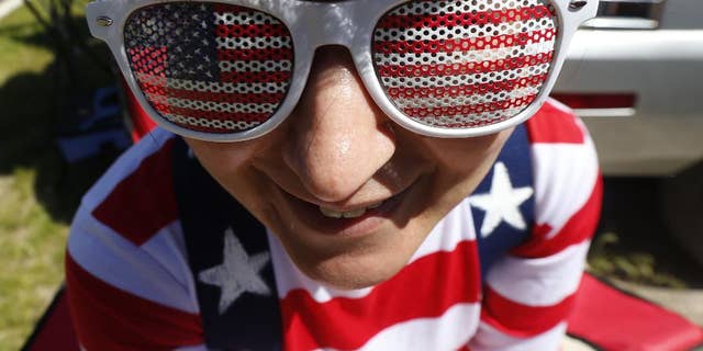 Michelle Whyte, 34, of Hoboken, N.J., wears the United States colors on her sunglasses and shirt while tailgating before the start of an international soccer friendly between Turkey and the United States, Sunday, June 1, 2014, in Harrison, N.J. (AP Photo/Julio Cortez)
