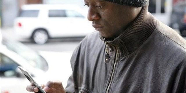 Bernard Toussaint, originally from Port-au-Prince, Haiti, tries to reach his mother in Haiti on his cell phone in New York, Wednesday, Jan. 13, 2010. The International Red Cross says a third of Haiti's 9 million people may need emergency aid and that it would take a day or two for a clear picture of the damage to emerge from Tuesday afternoon's magnitude-7.0 earthquake. (AP Photo/Seth Wenig)