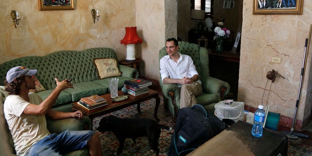 Co-founder of AirBnb Nathan Blecharczyk, right, visits with guesthouse owner Armando Usain in Havana, Cuba, Wednesday, June 24, 2015. AirBnb has added more than 2,000 listings in Cuba, which has long had an extensive network of legal private home for rent to travelers. (AP Photo/Desmond Boylan)