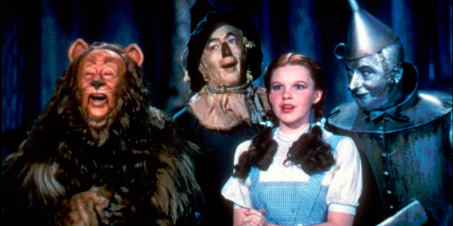 Bert Lahr as the Cowardly Lion, Ray Bolger as the Scarecrow, Judy Garland as Dorothy and Jack Haley as the Tin Woodman in a scene from "The Wizard of Oz."