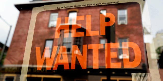 FILE - In this Aug. 19, 2013 file photo, a Philadelphia business displays a help wanted sign in its storefront. The Labor Department releases weekly jobless claims on Thursday, April 2, 2015. (AP Photo/Matt Rourke, File)