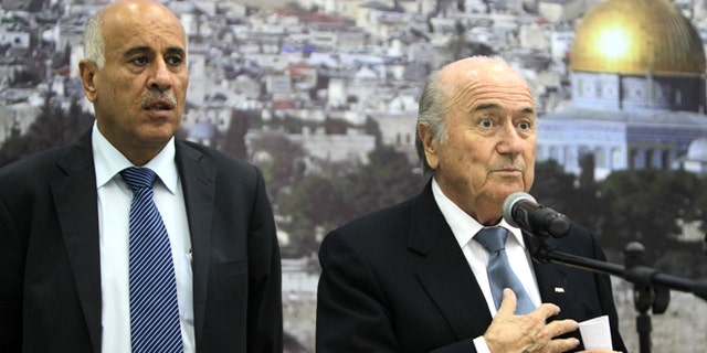 FIFA President Sepp Blatter (R) speaks as Palestinian Football Association chairman Jibril Rajoub listens on during a press conference in the West Bank city of Ramallah on July 7, 2013. Blatter is on a four-day-official visit to the Palestinian territories and Israel and neighboring Jordan during which he will notably launch football turf fields. AFP PHOTO/ABBAS MOMANI (Photo credit should read ABBAS MOMANI/AFP/Getty Images)